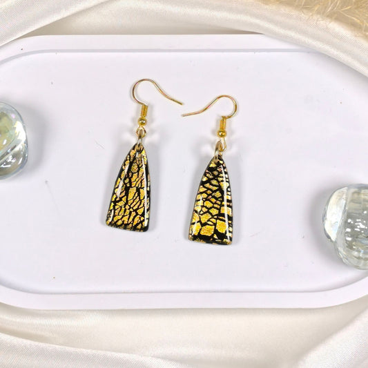  "Black and gold handmade polymer clay statement earrings with gold leaf details"