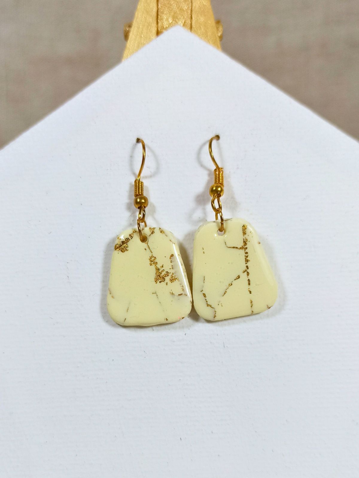 Medium size vanilla and gold dangle earrings